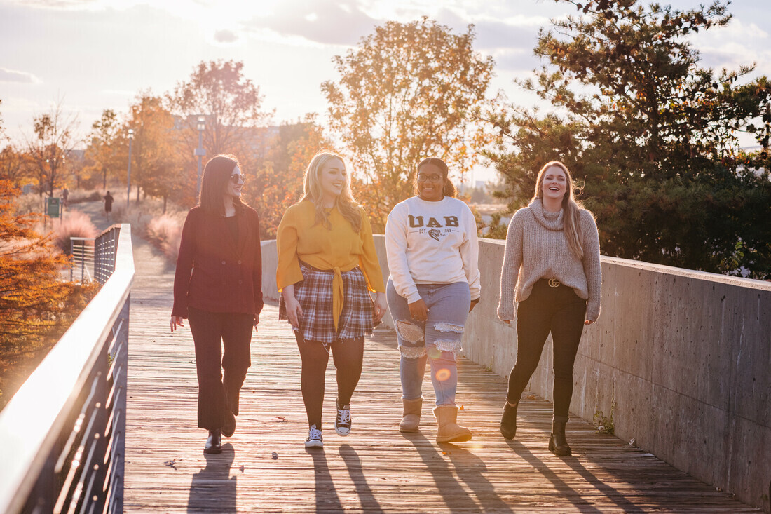 Students walking at sunset on UAB campus
